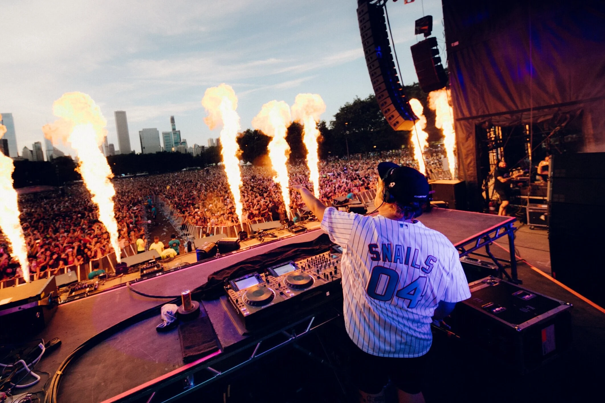 SNAILS performing for a festival crowd with stage pyrotechnics